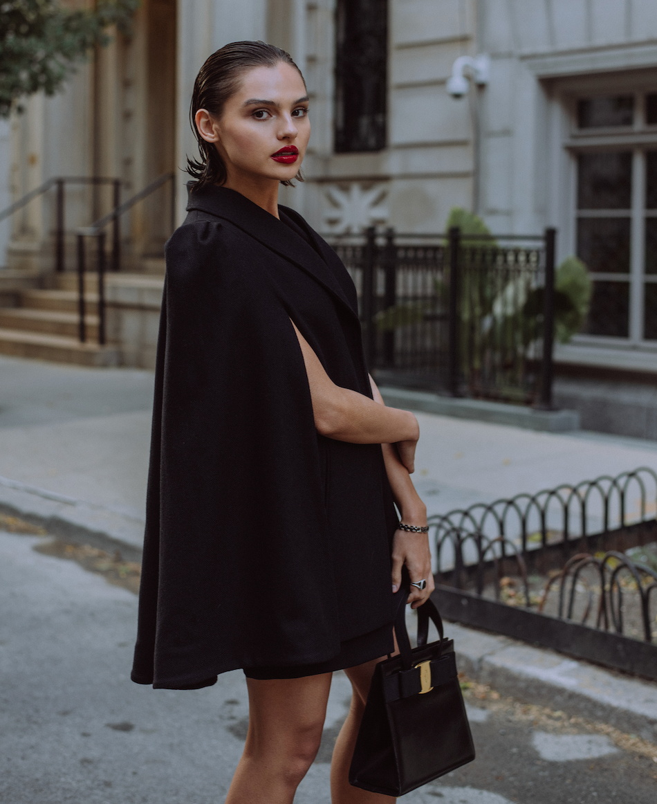 Fashionable woman in the city wearing a black Nina Nieves cape.