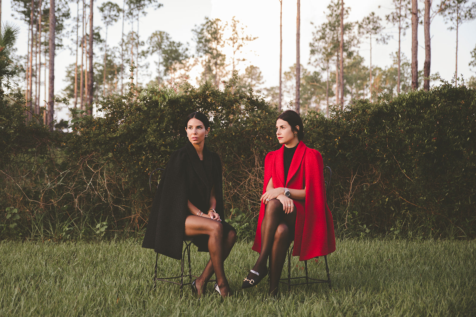Nina Nieves co-owners, Karol Jimenez Pagano and Kaidy Jimenez Solesky wear the new boucle knit capes, a tweed like fabric in red and black. 